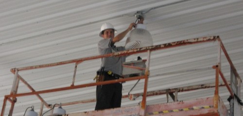 Dan House Electric servicing overhead cabling and lighting from a scissor lift