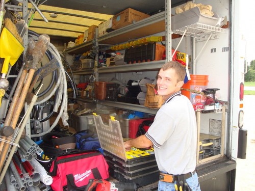 Dan House Electric electrician inside a fully stocked service truck — ready for 24/7 emergency dispatch