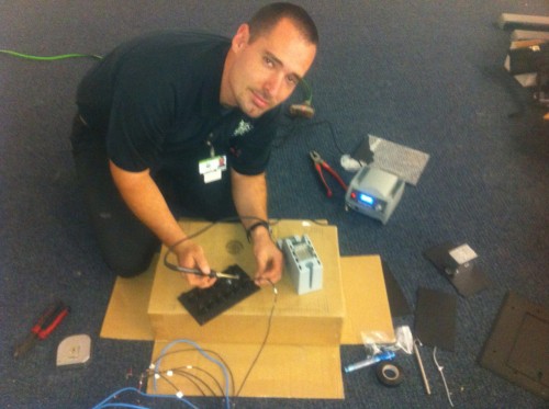 Dan House Electric technician wiring low-voltage CCTV and access-control equipment